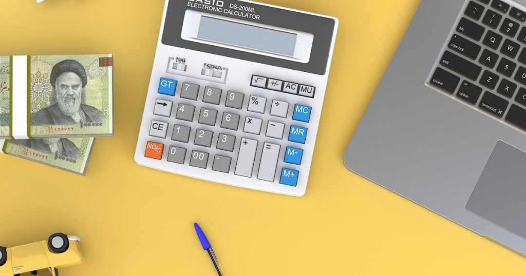 Calculator next to laptop showing annuity rate trend analysis