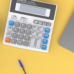 Calculator next to laptop showing annuity rate trend analysis